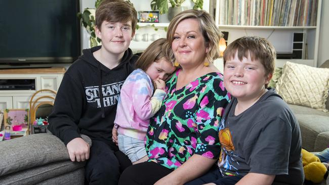 Amber Briggs with her children Flynn,13, Ivy, 5, and Ewan,10, at their Ethelton home waiting for her husband Andy to return from NSW. Picture: Mark Brake