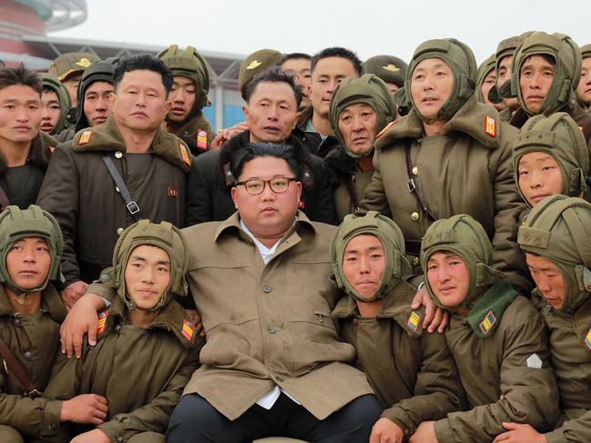 Kim Jong Un poses with members of North Korea’s air force. Picture: AFP