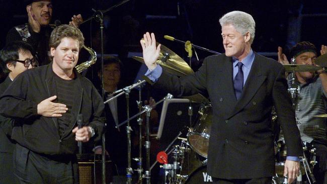 President Bill Clinton, right, on an official visit to South Korea in 1998, makes a surprise visit onstage with brother Roger who was performing with his band at Sejong Cultural Centre in Seoul.