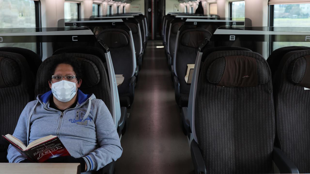 A passenger wearing a protective mask leaves Venice Santa Lucia Station to Rome as the country goes into lockdown. Picture: Marco Di Lauro/Getty Images