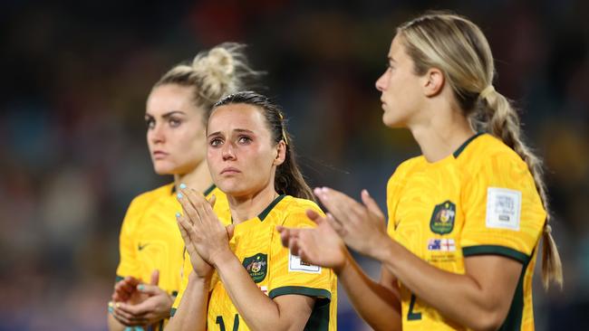 SYDNEY, AUSTRALIA – AUGUST 16: Hayley Raso (C) and Australia players applaud fans after the team's 1-3 defeat and elimination from the tournament following the FIFA Women's World Cup Australia & New Zealand 2023 Semi Final match between Australia and England at Stadium Australia on August 16, 2023 in Sydney, Australia. (Photo by Brendon Thorne/Getty Images)