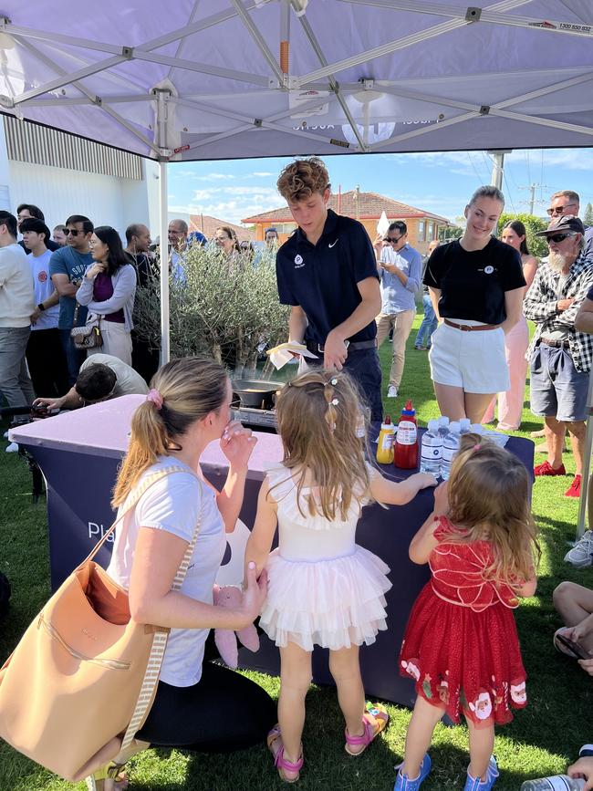 Families of all ages gathered for the morning sausage sizzle before the wild auction battle.