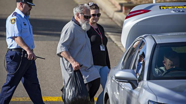 Guider carried two bags of possessions as he left. Picture: Toby Zerna. Photographer: Adam Yip