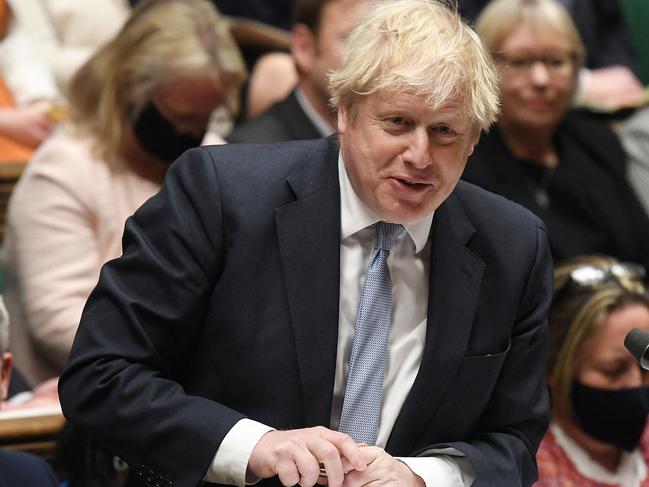 A handout photograph released by the UK Parliament shows Britain's Chancellor of the Duchy of Lancaster Stephen Barclay (L) reacting as Britain's Prime Minister Boris Johnson speaks at Prime Minister's Questions (PMQs) in the House of Commons in London on February 9, 2022. (Photo by JESSICA TAYLOR / UK PARLIAMENT / AFP) / RESTRICTED TO EDITORIAL USE - NO USE FOR ENTERTAINMENT, SATIRICAL, ADVERTISING PURPOSES - MANDATORY CREDIT 