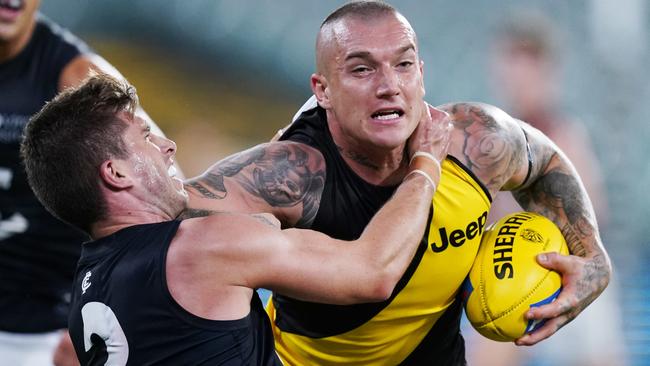 Dustin Martin tries to fend off Marc Murphy in Round 1.