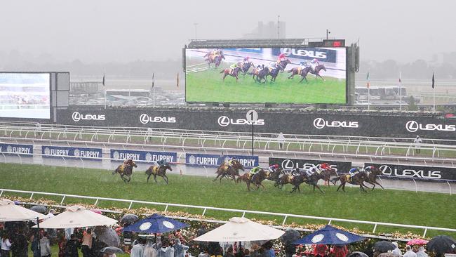 The rain pours down as runners complete the opening race. Pic: Getty Images