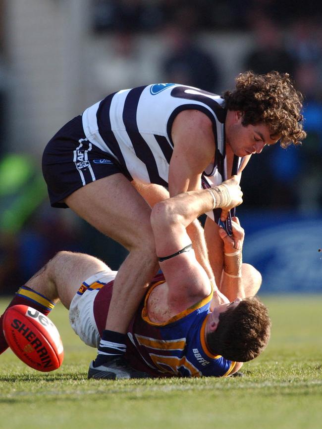 Brown wrestles with Geelong’s Matthew Scarlett in 2004. Picture: AAP Image/Stuart McEvoy.