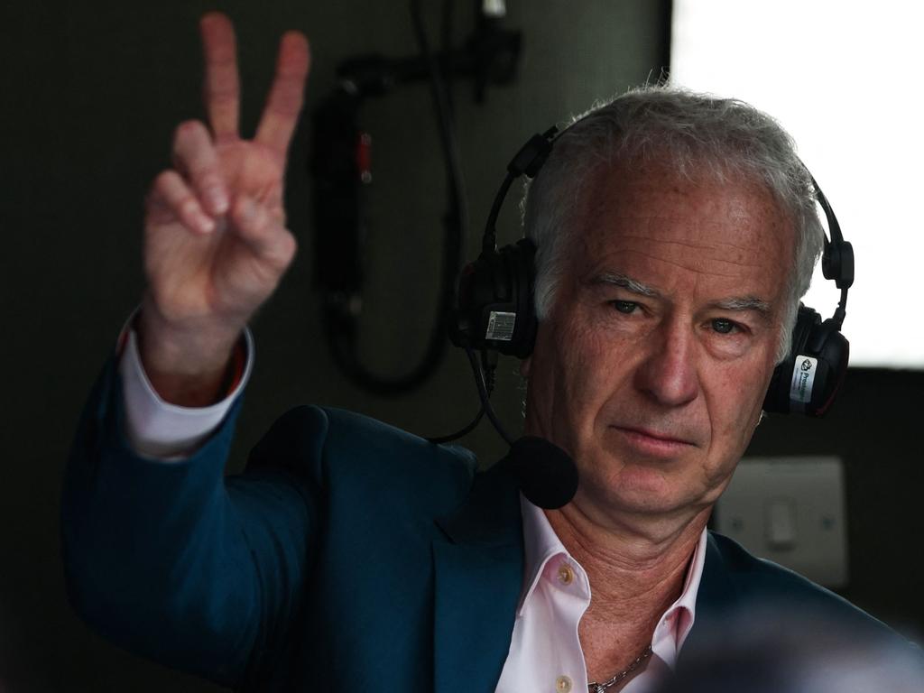 US former tennis player John McEnroe signs a "V" for victory prior to the men's singles final tennis match. Picture: AFP