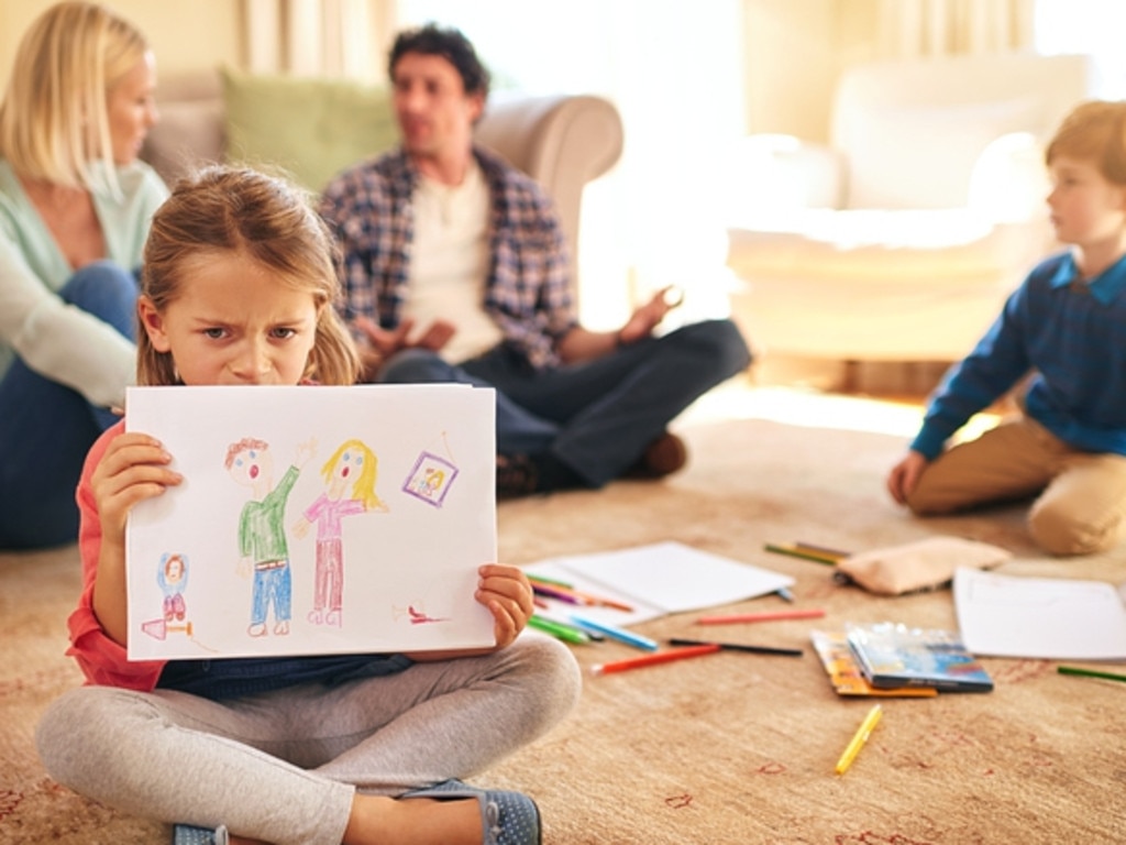 RendezView. Portrait of an unhappy daughter holding a drawing depicting domestic conflict. (Pic: iStock)