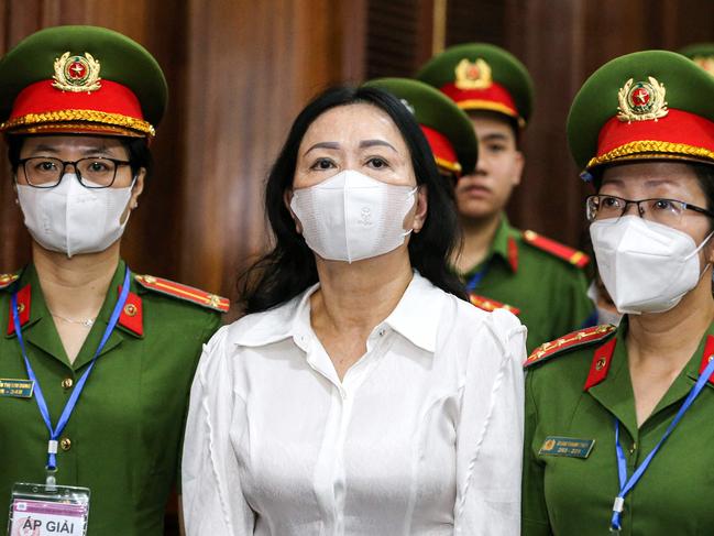 (FILES) Vietnam's property tycoon Truong My Lan (C) arrives at a court in Ho Chi Minh city on March 5, 2024. A top Vietnamese property tycoon will be sentenced on April 11, 2024 along with dozens of others, accused of embezzling $12.5 billion in the country's biggest ever fraud case. (Photo by AFP)