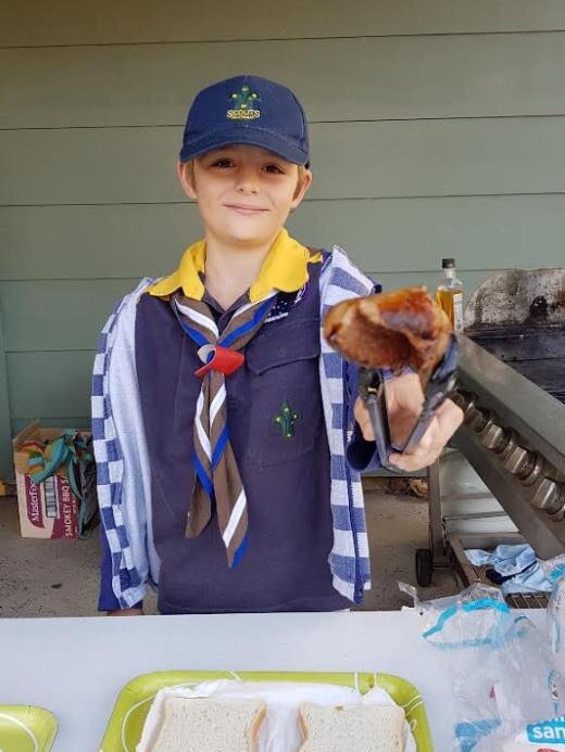 Joshua Bourne of 1st Point Clare Scots selling Democracy Sausages from $2.50.