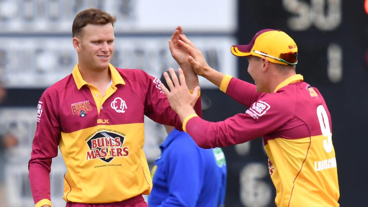 Matthew Kuhnemann (left) celebrates a wicket for Queensland with Marnus Labuschagne.