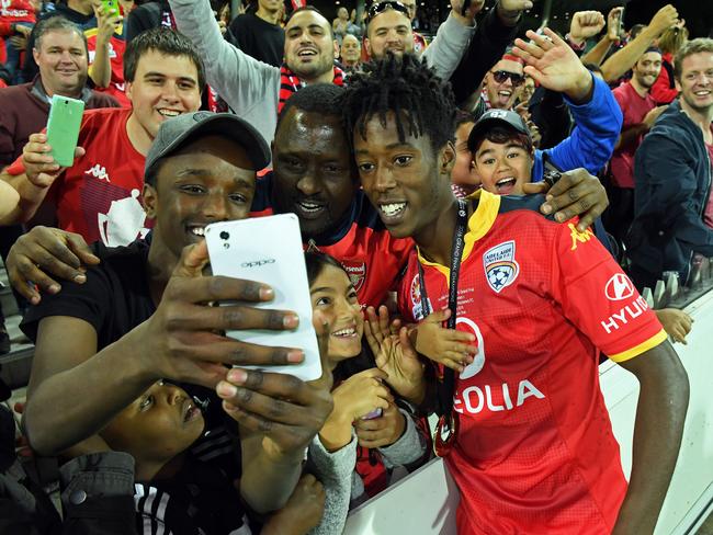 Bruce Kamau celebrates the victory with fans. Photo: Tom Huntley.