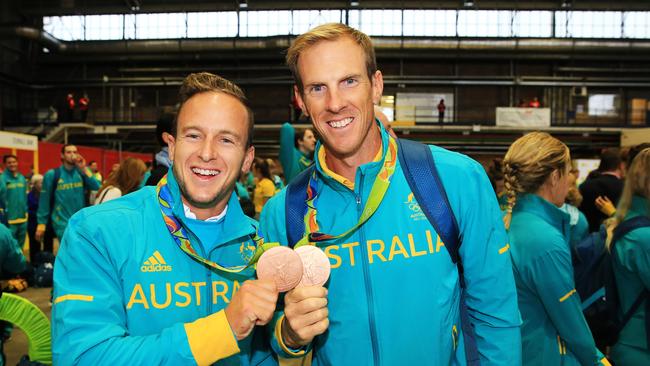 Kayakers, Lachlan Tame and Ken Wallace with their bronze medals as the Australian Olympians are welcomed home at Sydney Airport. pic Mark Evans