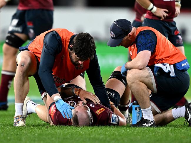 DUNEDIN, NEW ZEALAND - MAY 26: Connor Vest of the Reds receives medical assistance during the round 14 Super Rugby Pacific match between Highlanders and Queensland Reds at Forsyth Barr Stadium, on May 26, 2023, in Dunedin, New Zealand. (Photo by Joe Allison/Getty Images)