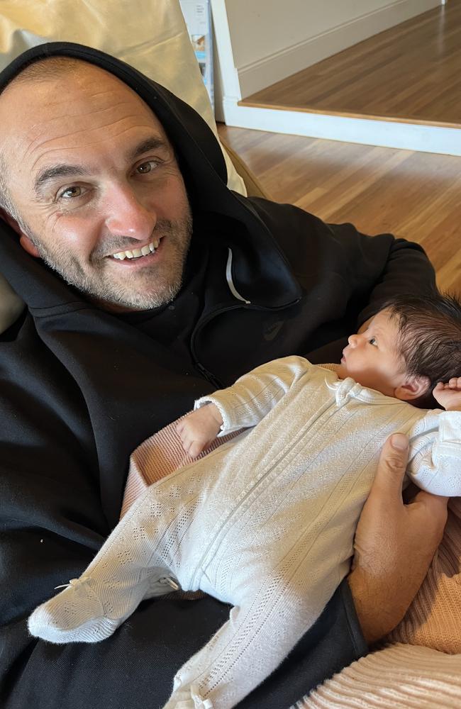 Ben Williams with Port Adelaide captain Connor Rozee's newborn daughter, Audrey.