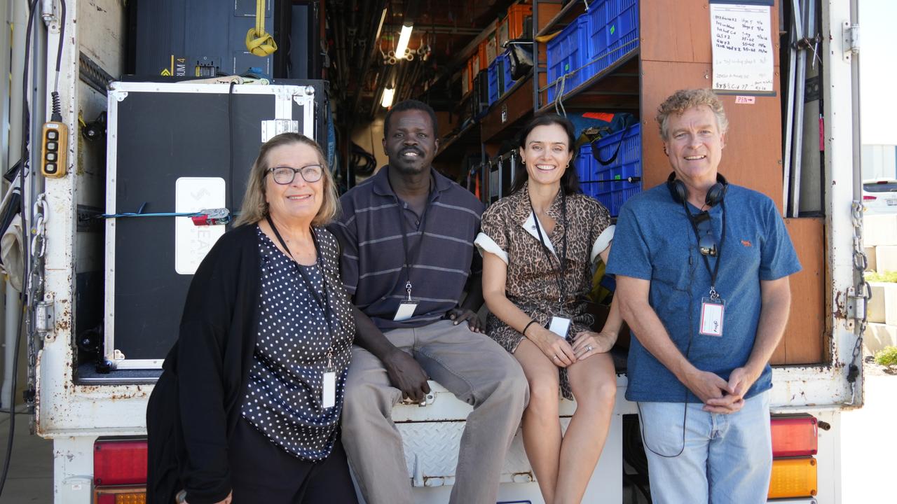 On the set of the Australian independent film Spit, a sequel to 2003 classic Gettin' Square, at the Queensland Regional Accommodation Centre near Toowoomba Wellcamp Airport. Film producers Trish Lake, Felicity McVay and Greg Duffy with actor Ayik "Daniel" Chut Deng (centre left).