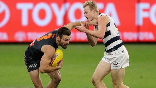 Stephen Coniglio evading Zach Guthrie (Photo by Will Russell/AFL Photos via Getty Images)