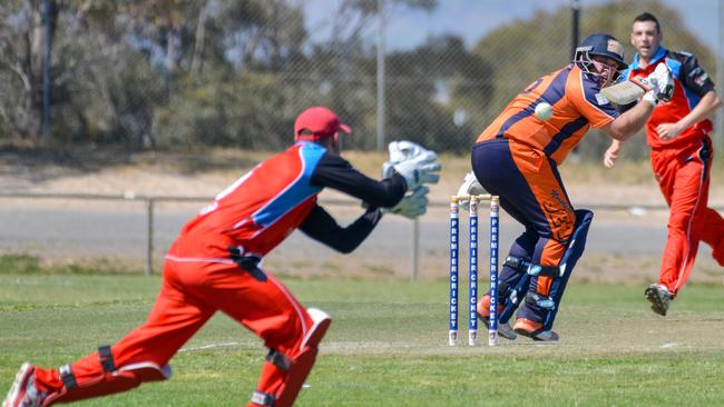 Northern Districts captain/coach Mark Cosgrove batting as Southern Districts keeper and captain Joshua Barrett waits for the ball. Picture: AAP/Brenton Edwards