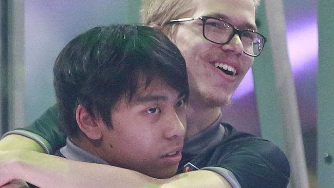 VANCOUVER, BC - AUGUST 25: Anathan Pham (L) and Topias Taavitsainen of OG hug after their 3-2 win over PSG.LGD in their grand final Dota 2 match on Day 6 of The International 2018 at Rogers Arena on August 25, 2018 in Vancouver, Canada. OG won $11,210,380 with the victory. (Photo by Jeff Vinnick/Getty Images)