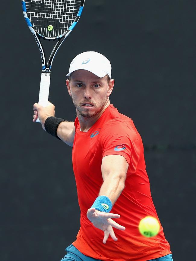 James Duckworth plays a forehand against Luke Saville.