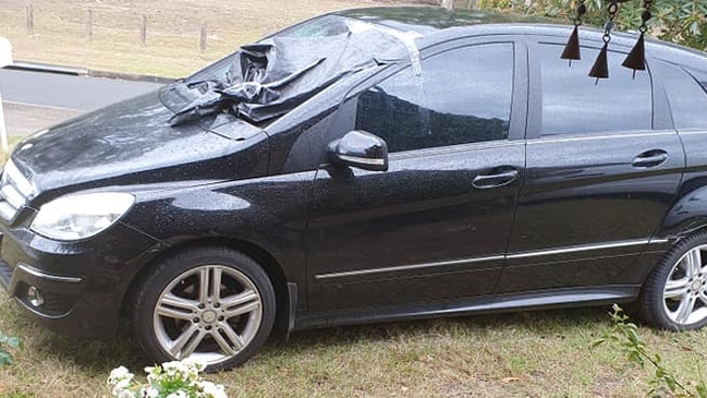 The black Mercedes hatchback abandoned in a Brisbane front yard.