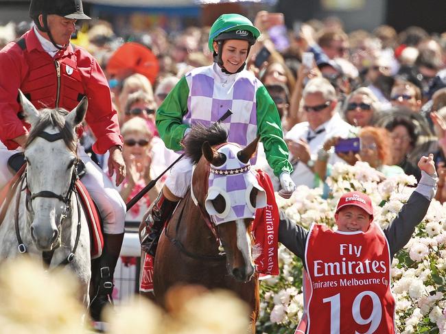 Michelle Payne, flanked by strapper and brother Steven Payne, after Prince Of Penzance won the 2015 Melbourne Cup.