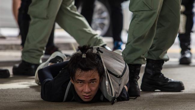 Riot police detain a man as they clear protesters taking part in a rally against a new national security law in Hong Kong. Picture: AFP