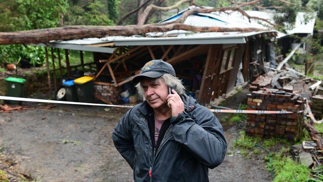 A large tree crashed on to the home of Ian Dyson on at Bridgewater. Ian is on the phone to his insurance company. Picture: Campbell Brodie.