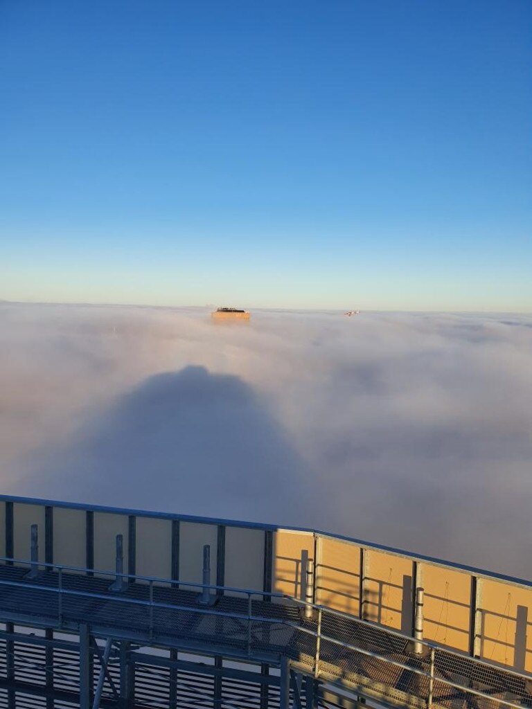 The CBD pokes above the clouds as seen from the Realm Apartments in Adelaide, the newly completed tallest building in the city. Picture: Maxcon