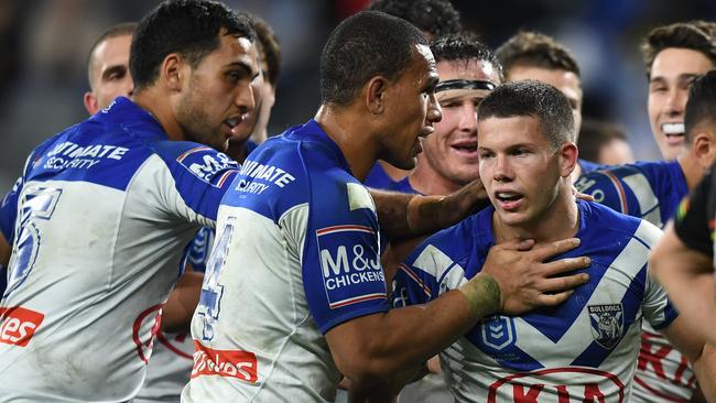 Jack Cogger celebrates a try with his Bulldogs teammates. Picture: AAP