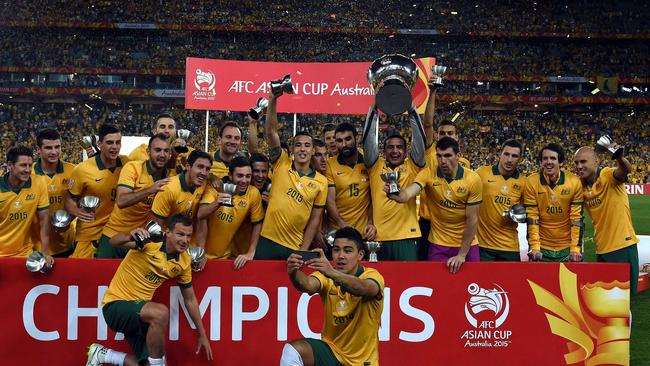 Australia's Tim Cahill (C) and teammates celebrate, while taking selfies.