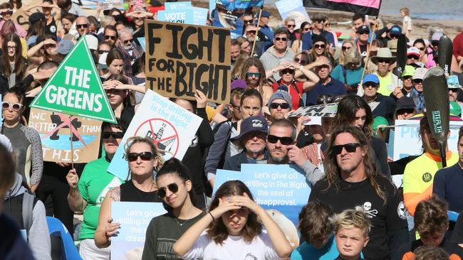 Protesters on the sand at Brighton beach hold signs opposing oil drilling in the Great Australian Bight. Picture: AAP / Emma Brasier