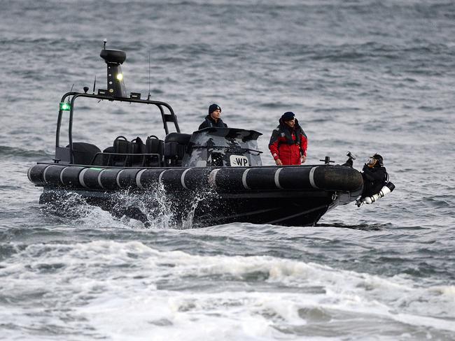 Police divers search for a missing child in the ocean off Pearl Beach on the NSW central coast. Picture: Peter Clark