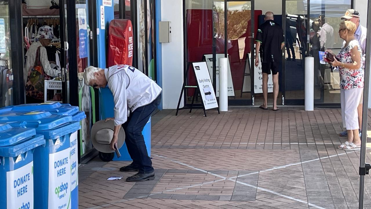 Federal MP Bob Katter stands in a pre-poll exclusion zone in front of an op-shop RSPCA shop, as pre-poll voters walk into the booth. Picture: Chris Burns