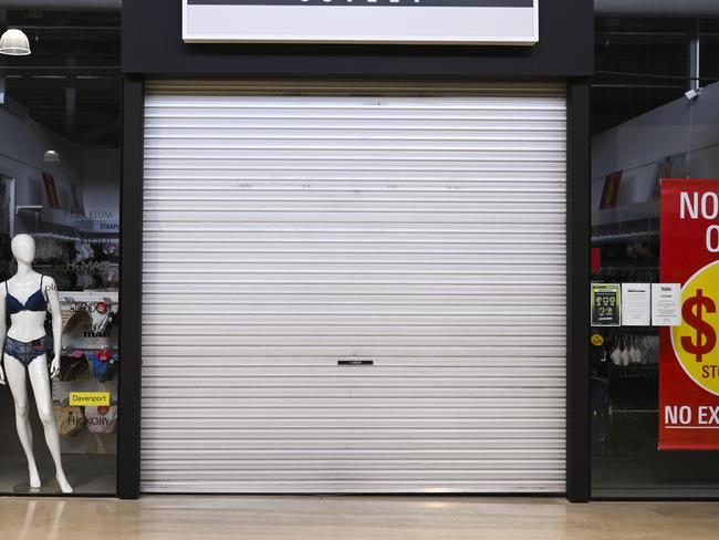 A closed shop front is seen inside an Outlet Shopping Centre in Canberra, Wednesday, April 15, 2020. (AAP Image/Lukas Coch) NO ARCHIVING