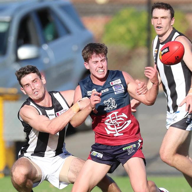 Castlemaine’s Bailey Henderson tackles his Sandhurst opponent.