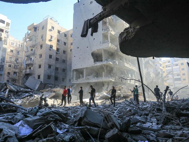 People walk amid the rubble of buildings levelled by Israeli strikes that targeted and killed Hezbollah leader Hassan Nasrallah in Beirut's southern suburbs. Picture: AFP