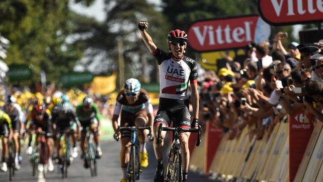 Ireland's Daniel Martin celebrates as he crosses the finish line to win the sixth stage of the 105th edition of the Tour de France. He was awarded the race’s most aggressive rider prize / AFP PHOTO / Marco BERTORELLO