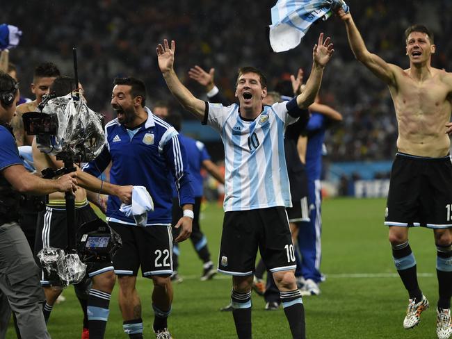 Argentina's forward and captain Lionel Messi celebrates with his teammates after winning their FIFA World Cup semi-final match against the Netherlands in a penalty shoot-out following extra time at The Corinthians Arena in Sao Paulo on July 9, 2014. AFP PHOTO / FABRICE COFFRINI