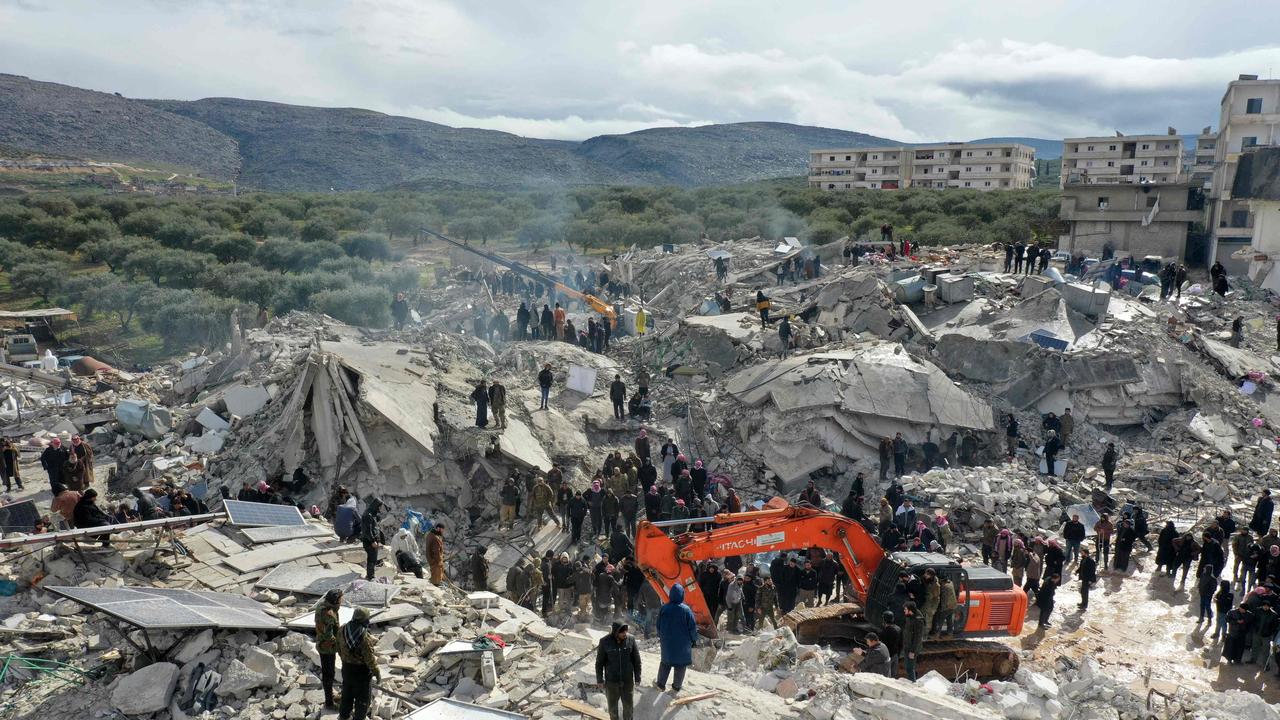 Residents searching for survivors under the rubble of collapsed buildings following an earthquake in the village of Besnia near the town of Harim, in Syria's rebel-held northwestern Idlib province on the border with Turkey (Photo by Omar HAJ KADOUR / AFP)