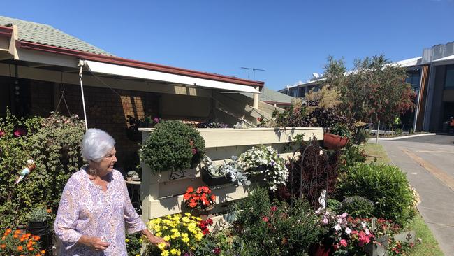 Shirley Bell inspects all the machinery and works outside her unit at Redhead Retirement Village