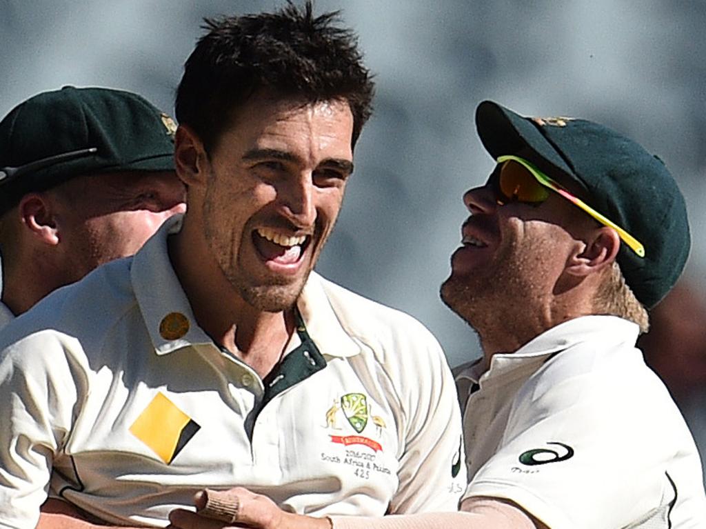 Mitchell Starc of Australia is embraced by teammate David Warner after defeating Pakistan in the Boxing Day test match between Australia and Pakistan at the MCG in Melbourne, Friday, Dec. 30, 2016. (AAP Image/Julian Smith) NO ARCHIVING, EDITORIAL USE ONLY, IMAGES TO BE USED FOR NEWS REPORTING PURPOSES ONLY, NO COMMERCIAL USE WHATSOEVER, NO USE IN BOOKS WITHOUT PRIOR WRITTEN CONSENT FROM AAP