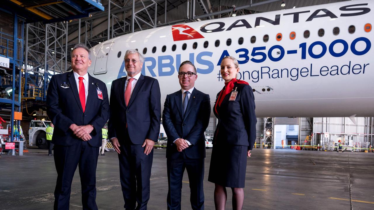 Chief Executive Officer of Qantas Airways Alan Joyce (2nd R) stands in front of the A350-1000 which will be used for long-haul flights to London and New York. Picture: Wendell TEODORO / AFP.