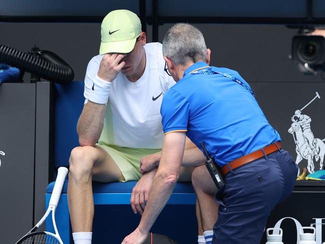 Italy's Jannik Sinner has a medical timeout whilst playing against Denmark's Holger Rune during their men's singles match on day nine of the Australian Open tennis tournament in Melbourne on January 20, 2025. (Photo by Martin KEEP / AFP) / -- IMAGE RESTRICTED TO EDITORIAL USE - STRICTLY NO COMMERCIAL USE --