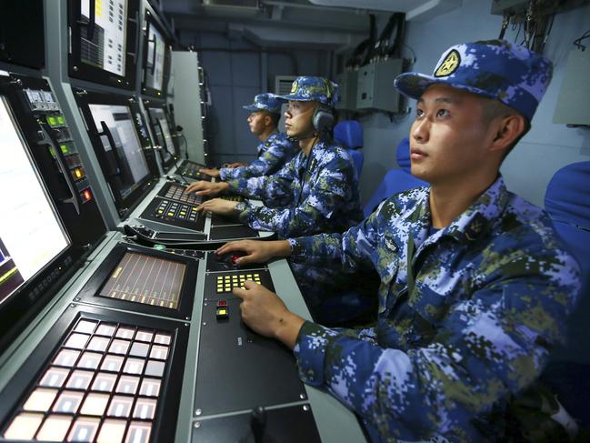 In this Friday, July 8, 2016 photo released by Xinhua News Agency, Chinese navy sailors search for targets onboard the missile destroyer Hefei during a military exercise in the waters near south China's Hainan Island and  Paracel Islands. They are controlled by Beijing but also claimed by Vietnam and Taiwan. China's navy is holding a week of military drills around the disputed islands ahead of a ruling by an international tribunal in a case filed by the Philippines challenging China's claim to most of the South China Sea. China is boycotting the case before The Hague-based court and says it will not accept the verdict. (Zha Chunming/Xinhua via AP)