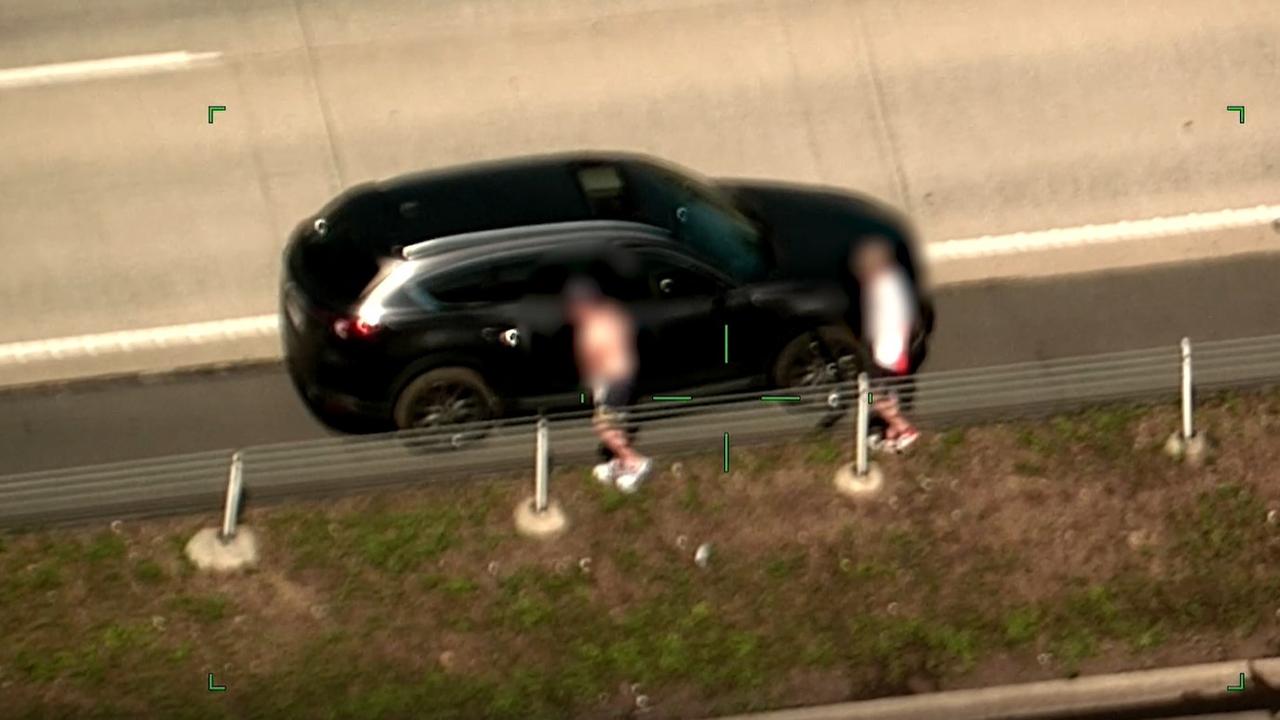 Polair vision of Taskforce Guardian and police arresting three juveniles in relation to a stolen car on Pacific Motorway at Yatala.