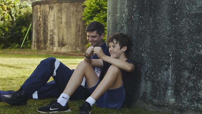 Critical care doctor Richard Parker with Eli Jarick – the 13-year-old boy he saved at Pine Creek near Bundaberg in front of the tree Eli fell six metres from in March.