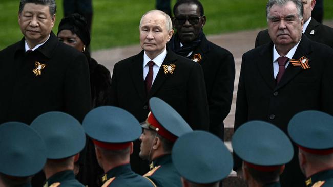 Russian President Vladimir Putin and foreign leaders, including Chinese President Xi Jinping, attend a ceremony to lay flowers at the Tomb of the Unknown Soldier by the Kremlin wall.