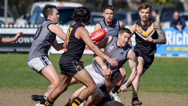 Louis Sharrad is tackled during an Adelaide Footy League division one game. Picture: Brenton Edwards